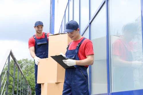 Movers carrying furniture through a property entrance