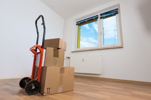 Loading furniture and boxes into a removals van in a Friern Barnet street