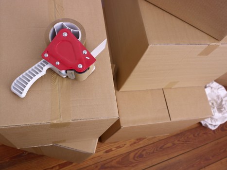 Packed office boxes and labelled equipment ready for a commercial move