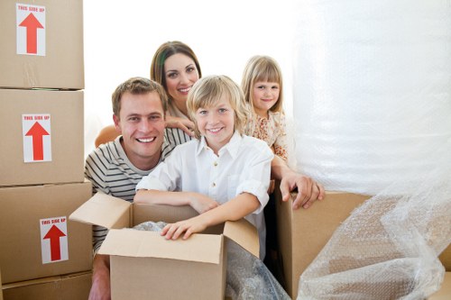 Loading household items into a removals van at a Friern Barnet property